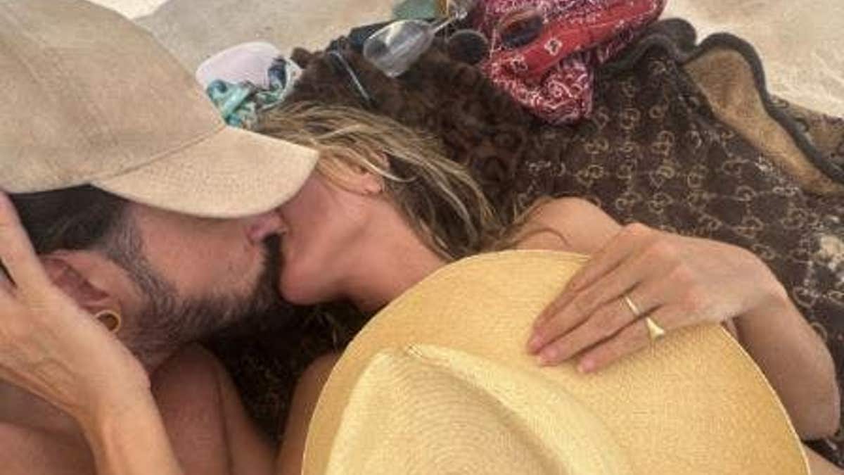 Heidi Klum kissing her husband