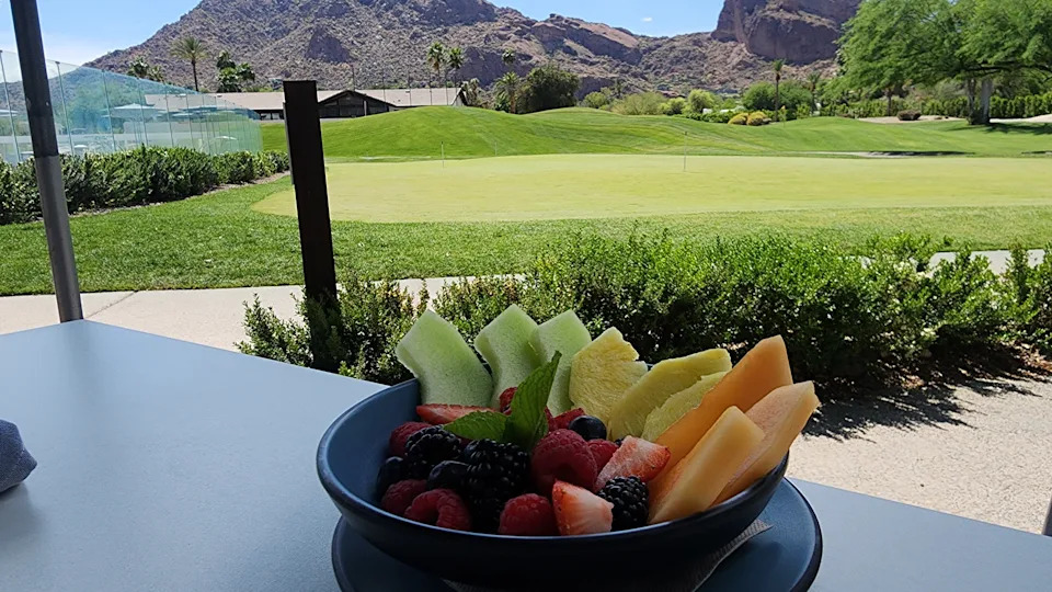 A fruite plate with a mountain in the distance