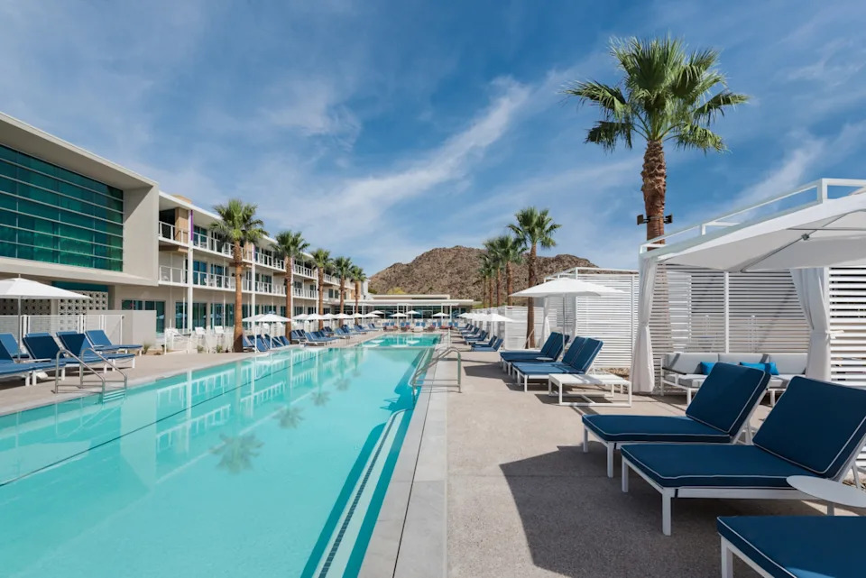 A brightly lit pool with a mountain in the distance