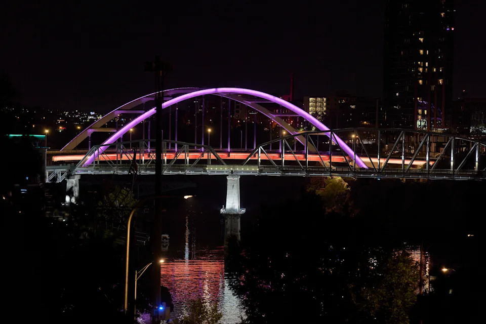 The Korean War Veterans Bridge is lit in pink lights to honor Dolly Parton, Tuesday, Aug. 25, 2026, in Nashville, Tenn. (AP Photo/George Walker IV)