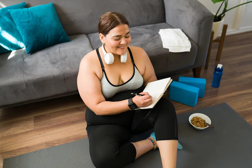 Person journaling after exercise, illustrating effective wellness habit pairings