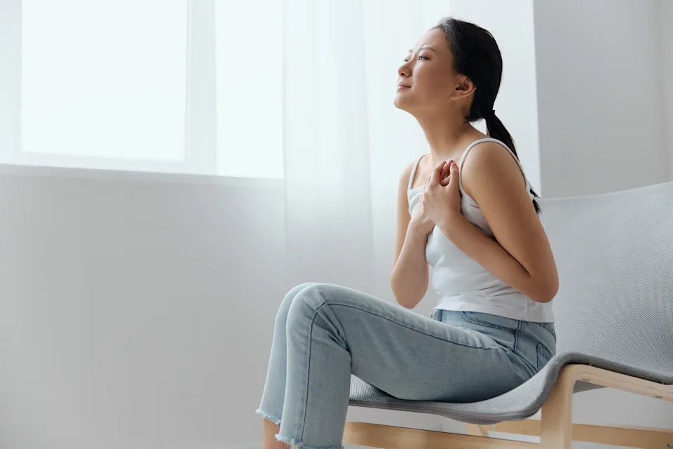 Person taking a calming deep breath, illustrating wellness stacking for anxiety and stress