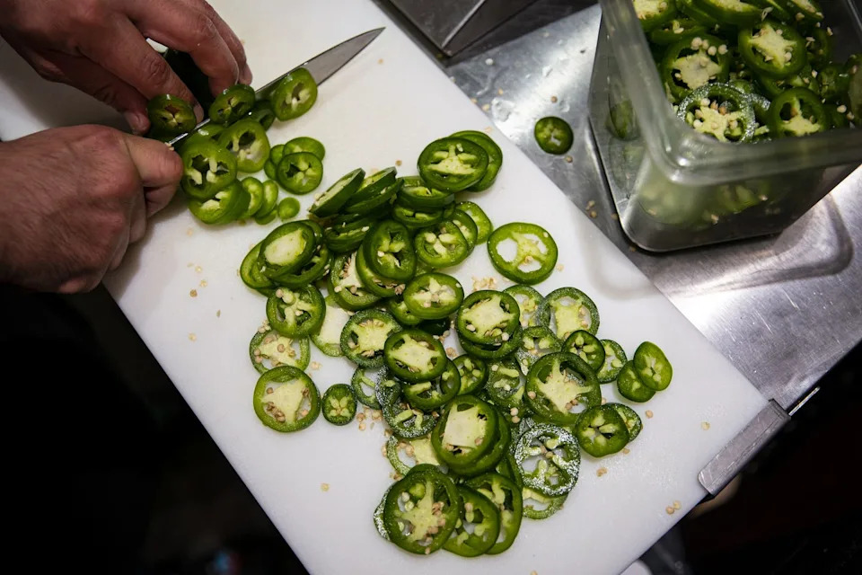 A Person Prepares Jalapeno Peppers