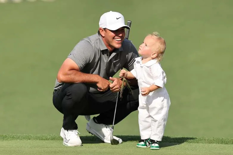 AUGUSTA, GEORGIA - APRIL 09: Brooks Koepka of the United States smiles with his son, Crew Sims Koepka, during the Par Three Contest prior to the 2025 Masters Tournament at Augusta National Golf Club on April 09, 2025 in Augusta, Georgia. (Photo by Michael Reaves/Getty Images)