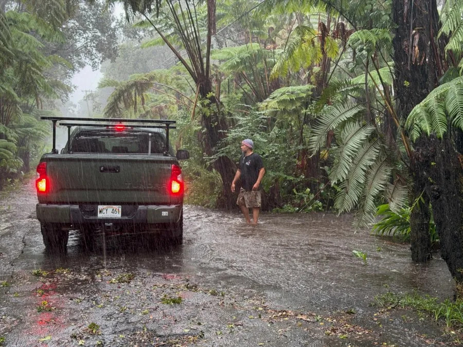 A resident stops on a rural road as it floods in Volcano Village on Hawaii Island, on August 15, 2026. Hurricane Lala on Saturday lashed Hawaii's Big Island with heavy rain and strong winds, as forecasters warned of potentially dangerous flooding across the US Pacific island state.Lala strengthened into a Category 1 hurricane at around 9:00 am local time (1900 GMT), generating winds of up to 75 miles per hour (120 kilometers per hour). (Photo by Jill K. Briggs / AFP via Getty Images)
