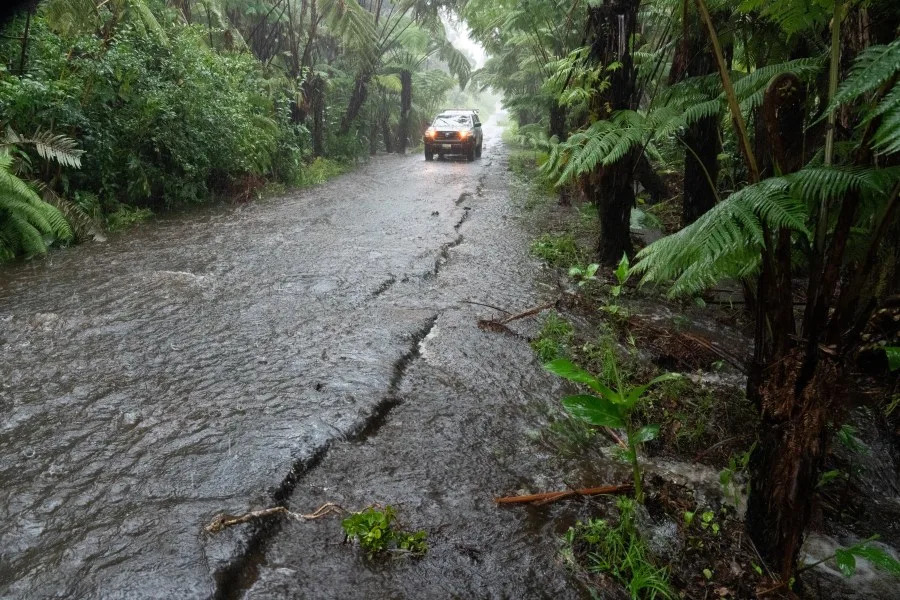 A rural road floods in Volcano Village on Hawaii Island, on August 15, 2026. Hurricane Lala on Saturday lashed Hawaii's Big Island with heavy rain and strong winds, as forecasters warned of potentially dangerous flooding across the US Pacific island state.Lala strengthened into a Category 1 hurricane at around 9:00 am local time (1900 GMT), generating winds of up to 75 miles per hour (120 kilometers per hour). (Photo by Jill K. Briggs / AFP via Getty Images)