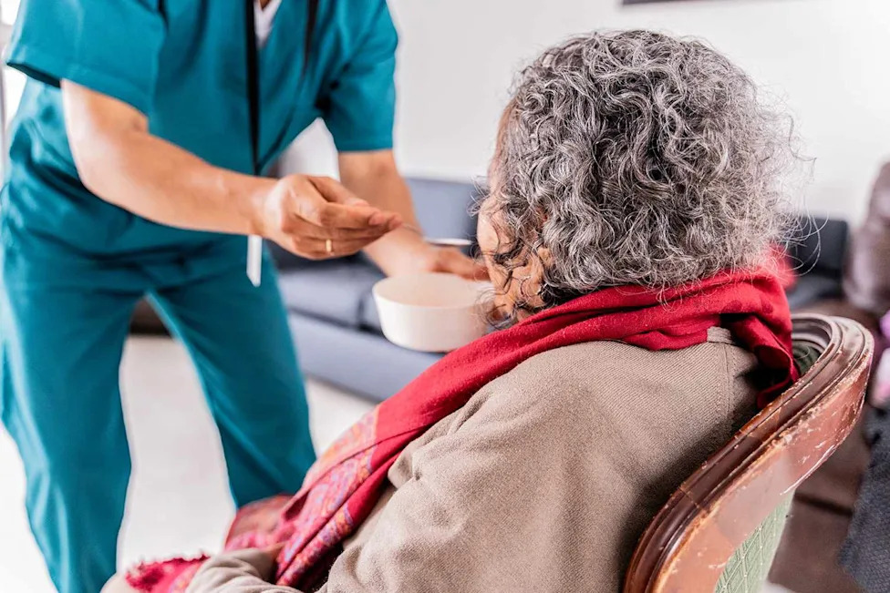 A senior woman being fed by a caregiver (stock image)Credit: Getty