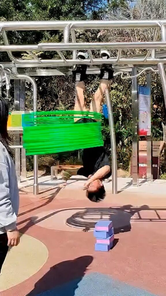 Watch: Man spins 33 hula hoops while upside down to break world record