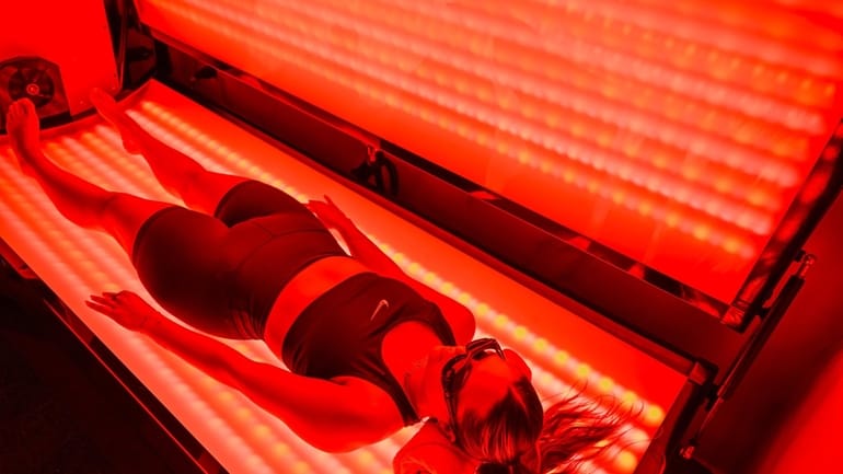 Assistant manager Felisa Bronzino demonstrates a red-light therapy session at...