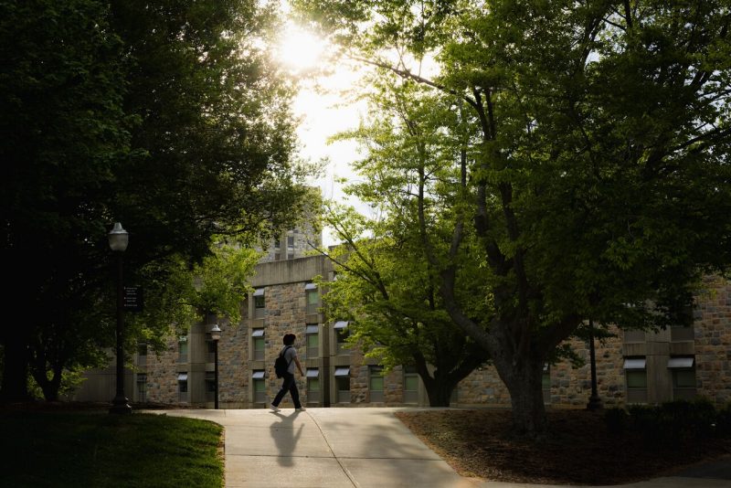 A student on campus at dusk during the spring 2026 semester.