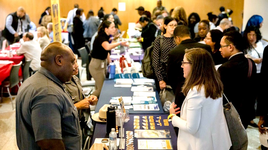 People talk at a job fair.
