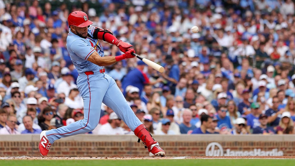 Joshua Báez swings and hits a home run at Wrigley Field during a Cardinals-Cubs game.