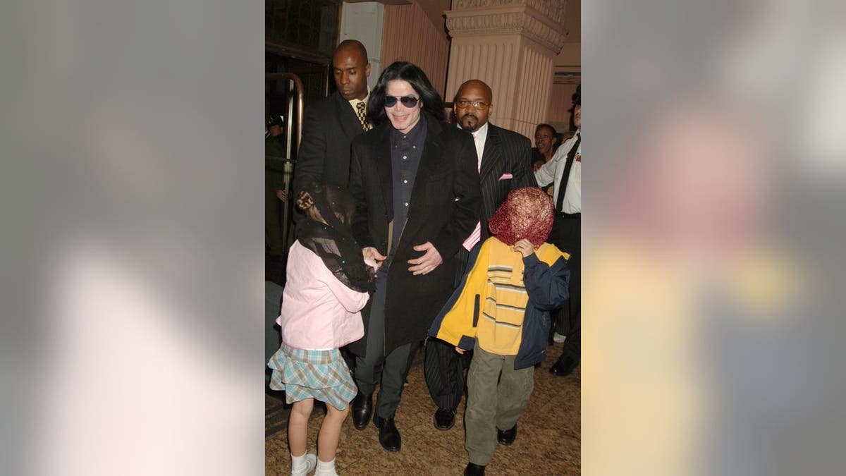 Michael Jackson walks with his children Prince and Paris inside Harrods in London.