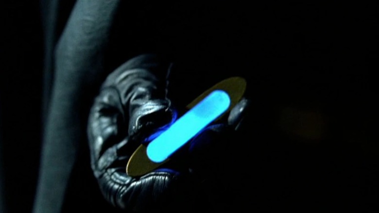Batman holding a Napalm Capsule