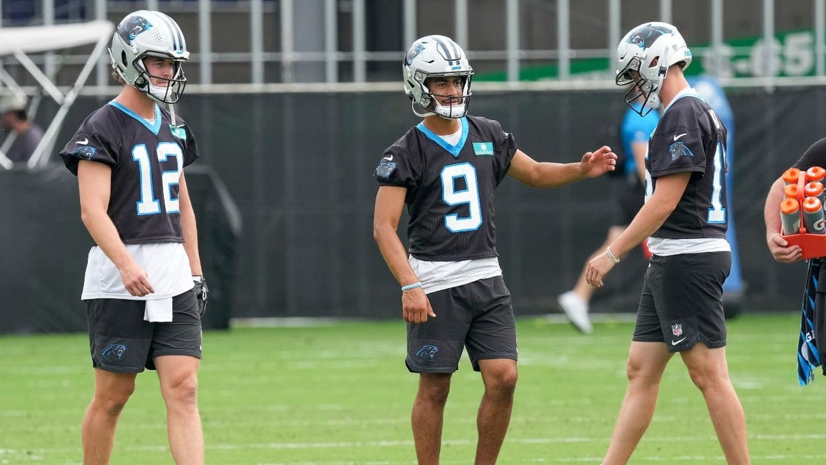 Carolina Panthers quarterbacks Bryce Young, Kenny Pickett, and Haynes King during training camp at Bank of America Stadium.