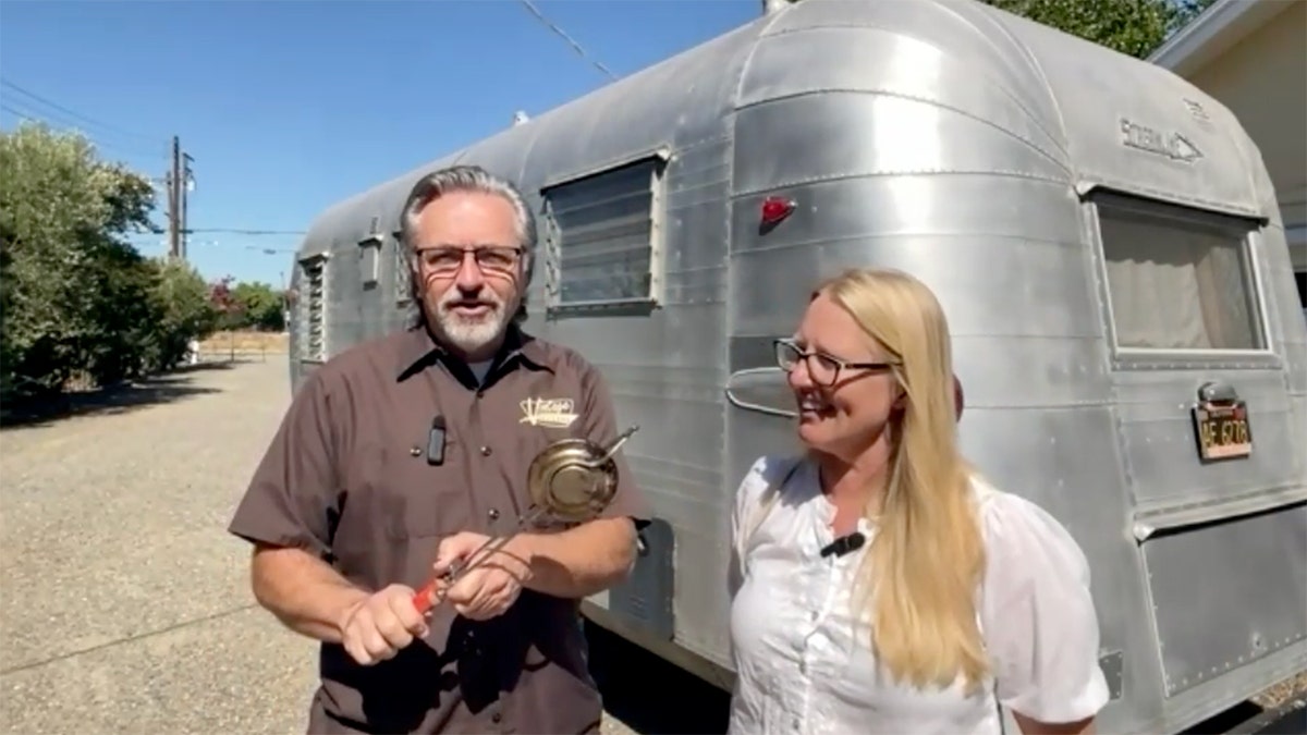 Paul and Caroline Lacitinola outside their vintage camper trailer