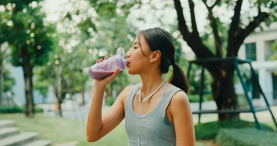 Person drinking a protein shake outside