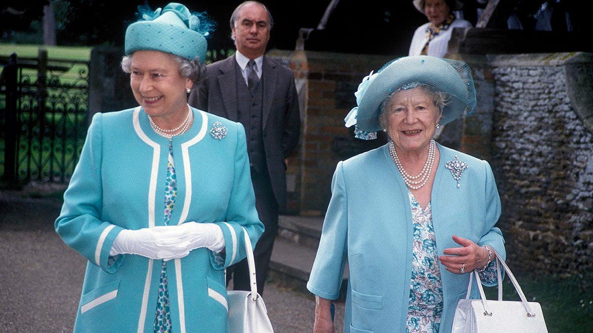 Queen Elizabeth II and Queen Elizabeth The Queen Mother pose together in 1990.