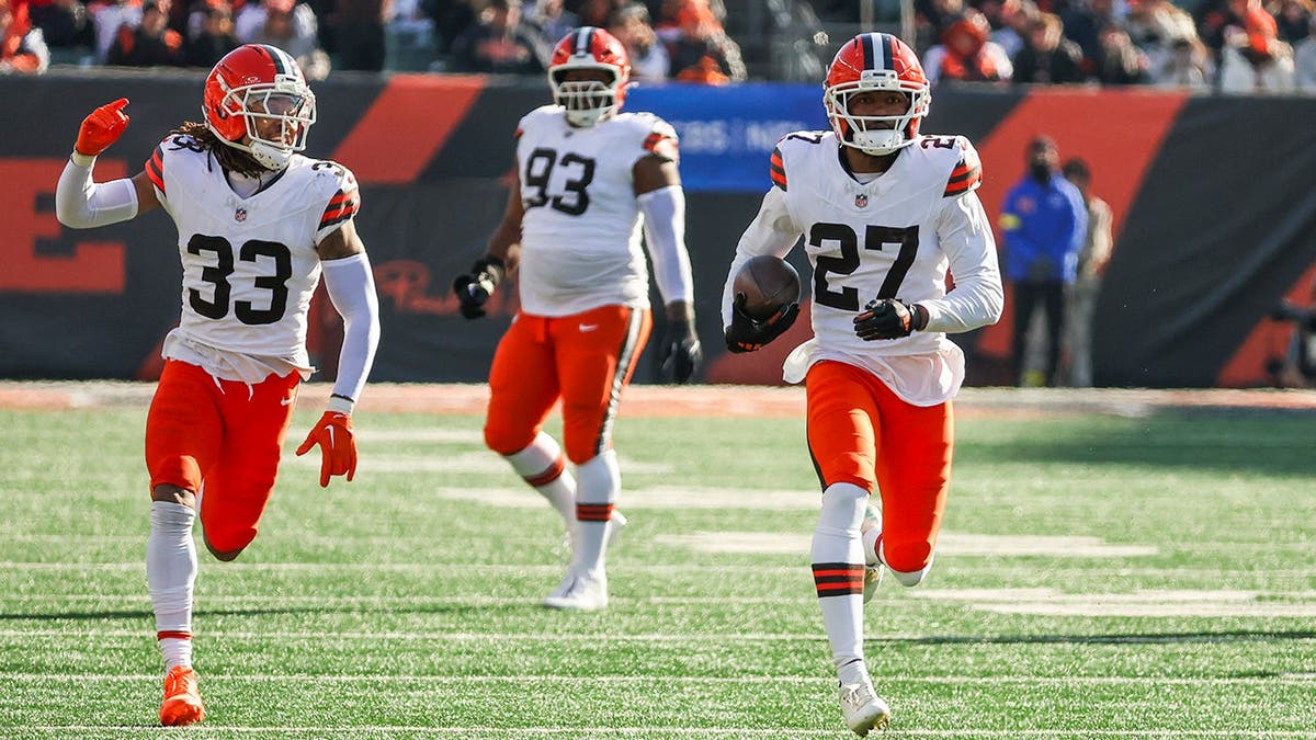 Sam Webb, wearing number 27, returns a fumble for a touchdown during an NFL game.