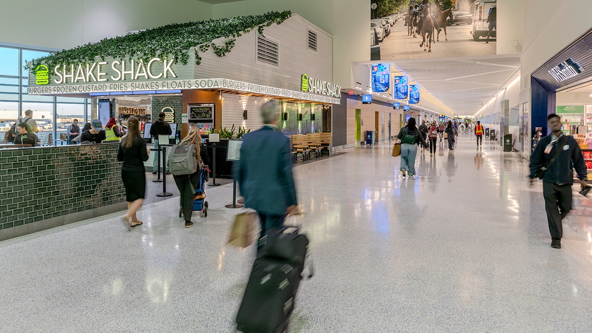 A Shake Shack is shown inside an airport.