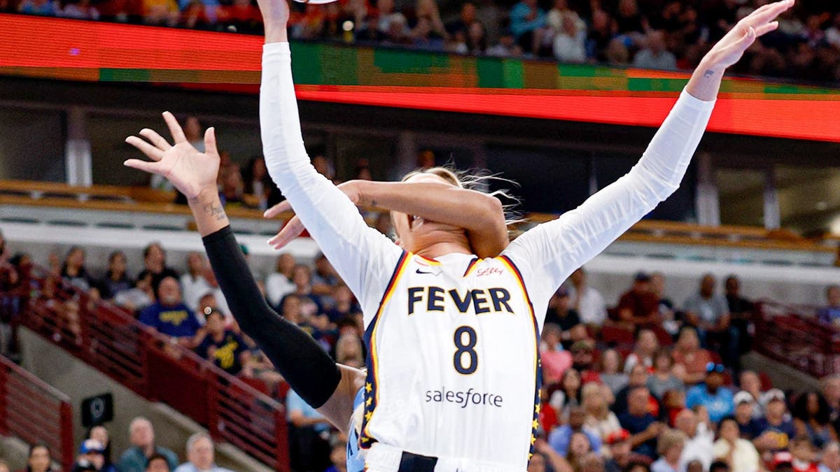 Sophie Cunningham drives to the basket as DiJonai Carrington fouls her during a WNBA game.