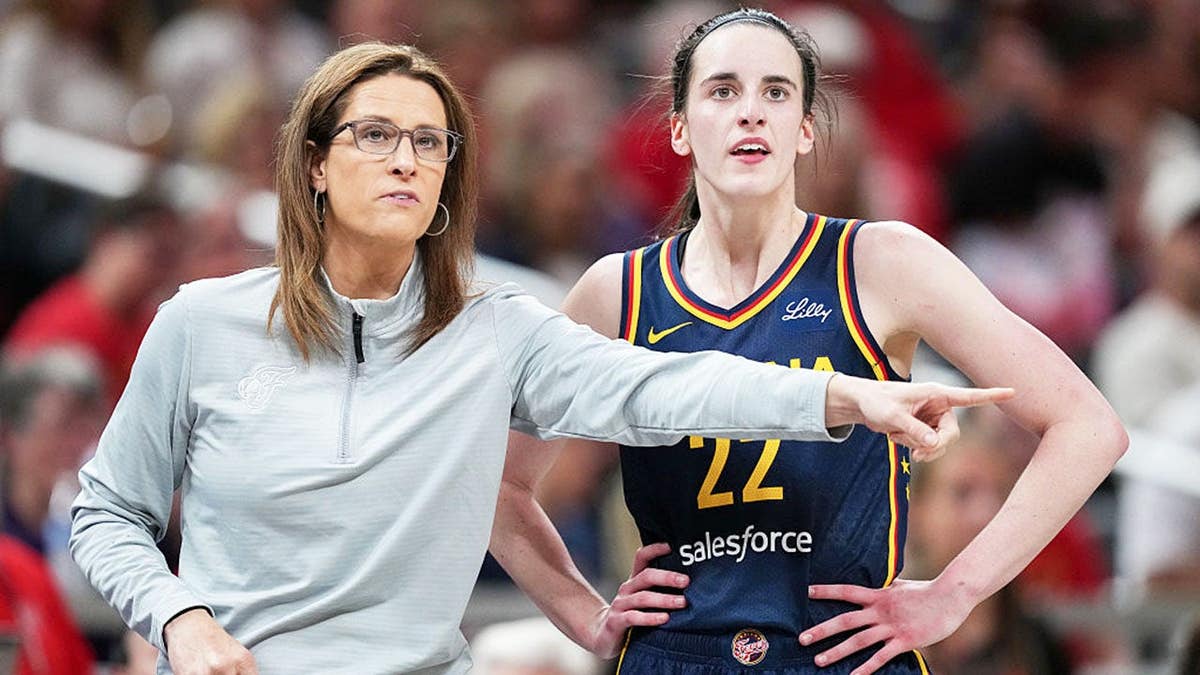 Head coach Stephanie White and Caitlin Clark of the Indiana Fever meet during a basketball game at Gainbridge Fieldhouse