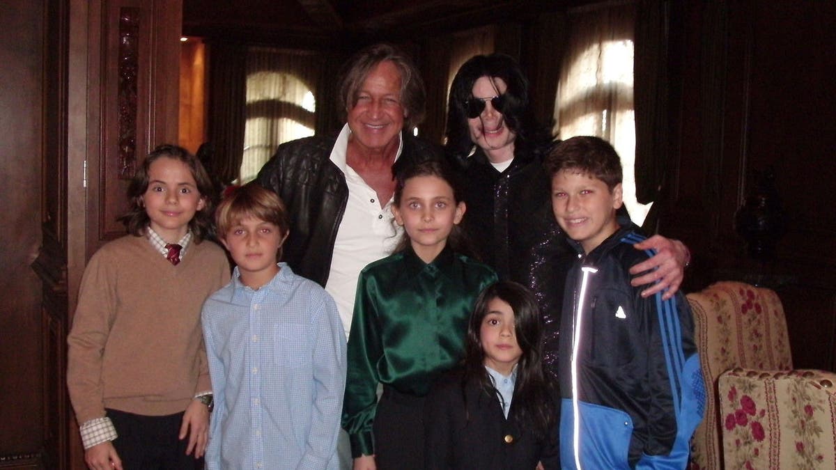 Michael Jackson poses with Mohamed Hadid and children at a Westwood residence.